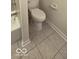 Bathroom with a standard toilet, tiled floors and a bathtub with tile walls, and chrome fixtures at 8277 Sobax Dr, Indianapolis, IN 46268