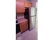 A stainless steel refrigerator stands near wood cabinets and laminate counters at 8277 Sobax Dr, Indianapolis, IN 46268