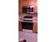 Kitchen featuring wood cabinets, laminate countertops, and stainless steel oven at 8277 Sobax Dr, Indianapolis, IN 46268