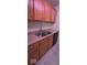 Kitchen featuring a stainless steel double sink, wood cabinets and laminate countertops at 8277 Sobax Dr, Indianapolis, IN 46268