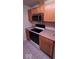 Kitchen with stainless steel microwave, white range, and wood cabinetry at 8277 Sobax Dr, Indianapolis, IN 46268
