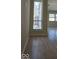 Sunlit living area featuring new laminated flooring, a large window, and a view to the outside patio at 8277 Sobax Dr, Indianapolis, IN 46268