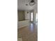 Bright living room with laminated floors, patio view, and a half wall separating the space at 8277 Sobax Dr, Indianapolis, IN 46268