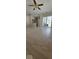 Spacious living room with hardwood floors, a ceiling fan, and sliding doors leading to the outside at 8277 Sobax Dr, Indianapolis, IN 46268