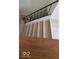 View of a wooden staircase with metal railing and light wood flooring, offering a blend of modern design and practicality at 8277 Sobax Dr, Indianapolis, IN 46268