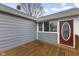 A back deck featuring a red door and grey siding at 8722 Shelby St, Indianapolis, IN 46227