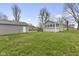 Spacious backyard featuring a detached garage and a serene view of the home at 8722 Shelby St, Indianapolis, IN 46227