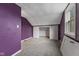 Bedroom featuring grey carpet, purple walls, and a closet with sliding doors at 8722 Shelby St, Indianapolis, IN 46227