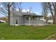 Classic home exhibiting a covered front porch with ramp, and a well-kept lawn at 8722 Shelby St, Indianapolis, IN 46227