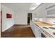 Spacious kitchen area featuring white cabinets, laminate countertops, and wood-look flooring at 8722 Shelby St, Indianapolis, IN 46227