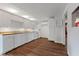 Bright kitchen with white cabinets, white appliances, and wood-look flooring at 8722 Shelby St, Indianapolis, IN 46227