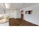 Bright kitchen with white cabinets, laminate countertops, and wood-look flooring at 8722 Shelby St, Indianapolis, IN 46227