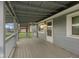 Charming covered porch showcasing a grey exterior and a welcoming entrance to the home at 8722 Shelby St, Indianapolis, IN 46227