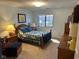 Bright bedroom with a comfortable bed, wooden furniture, and a window letting in natural light at 8820 Yardley Ct # 103, Indianapolis, IN 46268
