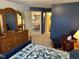Comfortable bedroom featuring a dresser, reading chair, ensuite bathroom and open view to the dining area at 8820 Yardley Ct # 103, Indianapolis, IN 46268