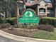Welcoming Yardley Court Condominiums sign with colorful flowers and well-maintained landscaping at 8820 Yardley Ct # 103, Indianapolis, IN 46268
