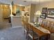 Open concept dining and living room area with chandelier, dining table and chairs at 8820 Yardley Ct # 103, Indianapolis, IN 46268