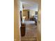 Hallway view looking into living room; features carpeting and wood trim entryway cabinet at 8820 Yardley Ct # 103, Indianapolis, IN 46268