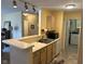 Galley kitchen features breakfast bar with seating and view of the in-unit laundry room at 8820 Yardley Ct # 103, Indianapolis, IN 46268