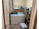 In-unit laundry room features washing machine, dryer and shelving for supplies at 8820 Yardley Ct # 103, Indianapolis, IN 46268