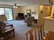 Bright living room features access to balcony, neutral carpeting and comfortable seating at 8820 Yardley Ct # 103, Indianapolis, IN 46268