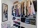 Organized walk-in closet with shelving, hanging rods, a mirror, and ample storage space at 9442 Avon Strand # D, Avon, IN 46123