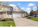 Inviting townhome with an attached garage, landscaped yard, and neutral exterior at 9442 Avon Strand # D, Avon, IN 46123