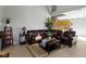 Open-concept living area featuring a brown leather sofa, staircase, and bright natural light at 9442 Avon Strand # D, Avon, IN 46123
