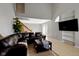 Bright living room with a vaulted ceiling, comfortable seating, and staircase at 9442 Avon Strand # D, Avon, IN 46123