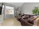 Inviting living room with a comfortable leather sectional and a view of the entrance at 9442 Avon Strand # D, Avon, IN 46123