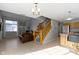 An open living space connecting the kitchen, living room, and staircase at 9442 Avon Strand # D, Avon, IN 46123