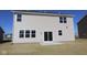 Exterior of the home showcasing the sliding glass doors and backyard area with a concrete patio at 10027 Redwood Peak Ln, Indianapolis, IN 46259