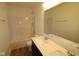 Bright bathroom featuring a bathtub and shower combination, double sink vanity, and a large mirror at 10027 Redwood Peak Ln, Indianapolis, IN 46259