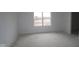 Bright, unfinished bedroom showing a large window and fresh, clean walls at 10027 Redwood Peak Ln, Indianapolis, IN 46259