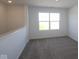 Bright room with carpeted floors and fresh white paint, offering plenty of natural light at 10027 Redwood Peak Ln, Indianapolis, IN 46259