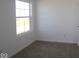 Bright bedroom featuring neutral carpeting, white walls, and a window at 10027 Redwood Peak Ln, Indianapolis, IN 46259
