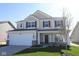 Charming two-story home with a two-car garage, stone accents, and well-maintained landscaping at 10027 Redwood Peak Ln, Indianapolis, IN 46259