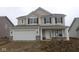 Inviting two-story home with neutral siding, a two-car garage, and classic black shutters at 10027 Redwood Peak Ln, Indianapolis, IN 46259