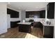 Modern kitchen featuring dark wood cabinets, white countertops, stainless steel appliances, and an island at 10027 Redwood Peak Ln, Indianapolis, IN 46259