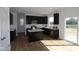 Modern kitchen featuring dark wood cabinets, white countertops, stainless steel appliances, and an island at 10027 Redwood Peak Ln, Indianapolis, IN 46259