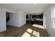 Open-concept living area with views of the kitchen, hardwood floors, and staircase at 10027 Redwood Peak Ln, Indianapolis, IN 46259