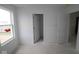 Bedroom featuring large window and adjoining doors into the ensuite bathroom at 10033 Redwood Peak Ln, Indianapolis, IN 46259