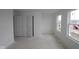 Bright bedroom with a neutral color palette, featuring two windows and dual closets at 10033 Redwood Peak Ln, Indianapolis, IN 46259