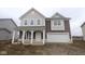 Charming two-story home with a welcoming front porch and attached two car garage at 10033 Redwood Peak Ln, Indianapolis, IN 46259