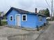 Single-story home with blue siding and a front door entrance at 1047 N Concord St, Indianapolis, IN 46222
