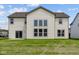 Back exterior view showcasing large windows and sliding door against a well-manicured lawn at 10543 Banyan Wood Ct, Indianapolis, IN 46239