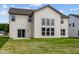 Back exterior view showcasing large windows and sliding door against a well-manicured lawn at 10543 Banyan Wood Ct, Indianapolis, IN 46239
