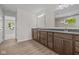 Bathroom features a double sink vanity with dark wood cabinets and granite countertops at 10543 Banyan Wood Ct, Indianapolis, IN 46239