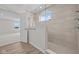 Beautifully tiled walk-in shower with glass enclosure and chrome fixtures in a modern bathroom at 10543 Banyan Wood Ct, Indianapolis, IN 46239