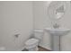 Cozy powder room with pedestal sink and modern fixtures, perfect for guests at 10543 Banyan Wood Ct, Indianapolis, IN 46239